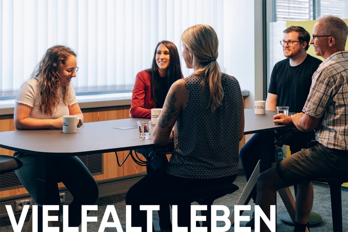 Mitarbeiter sitzen um einen Besprechungstisch.
